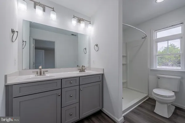 a bathroom with a toilet a sink and a mirror