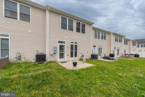 a view of a house with backyard sitting area and garden