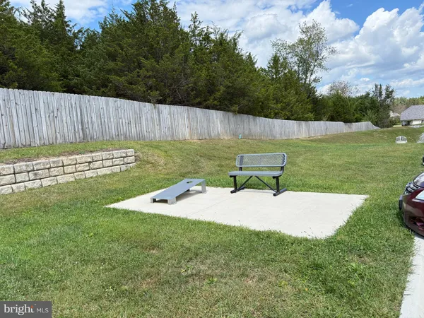 a view of a backyard with a garden and outdoor seating