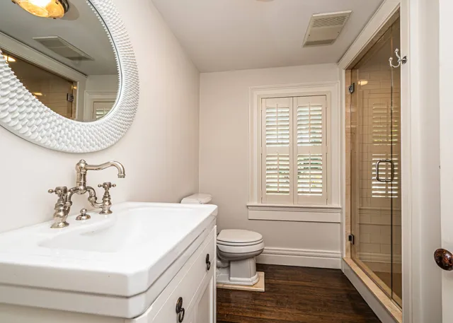 a bathroom with a sink a toilet and a shower