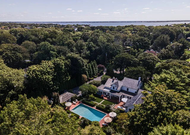 an aerial view of a house with a yard