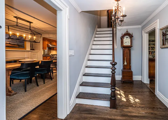a view of entryway and hall with wooden floor