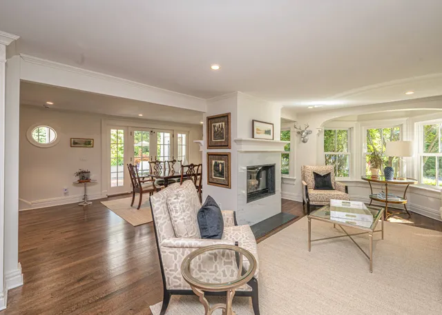 a living room with furniture a fireplace and a table