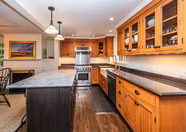 a large kitchen with stainless steel appliances granite countertop a stove and a sink