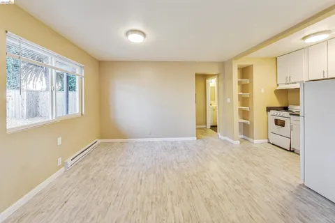 a view of a kitchen with a stove cabinets and wooden floor