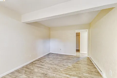 an empty room with fan and entrance