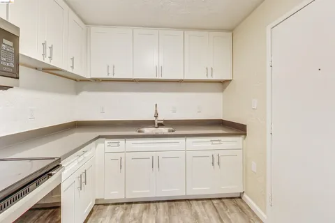 a view of a kitchen with a stove and refrigerator