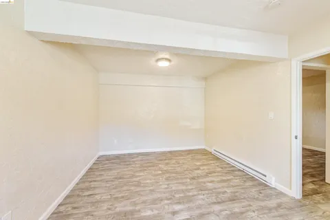 a view of an empty room and wooden floor