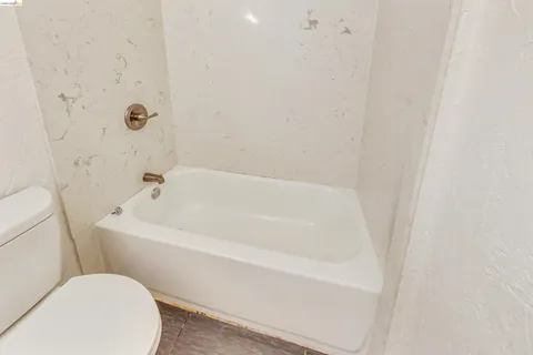 a white toilet sitting next to a bathroom sink