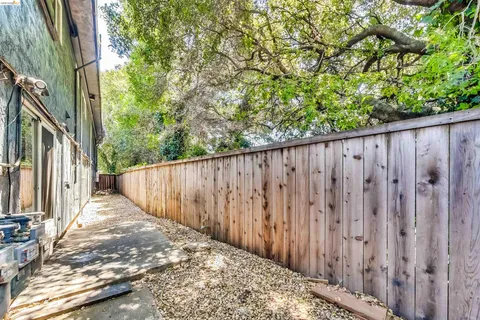 a view of a room with wooden floor and a ceiling fan