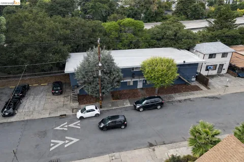 an aerial view of a house with yard and parking space