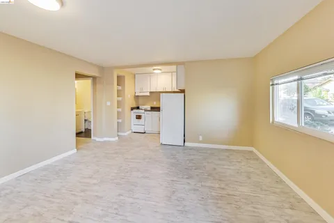 a view of a kitchen with a sink and a refrigerator