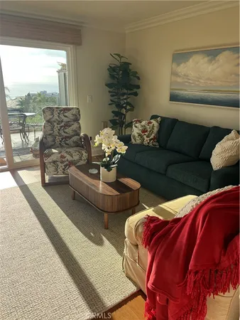 a bedroom with furniture and a large window