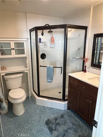 a bathroom with a toilet sink vanity and mirror