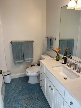 a bathroom with a sink a toilet and mirror