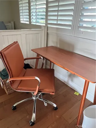 a view of a room with wooden floor and windows