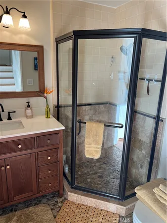 a bathroom with a sink a mirror and a shower