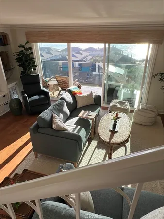 a living room with furniture and a floor to ceiling window
