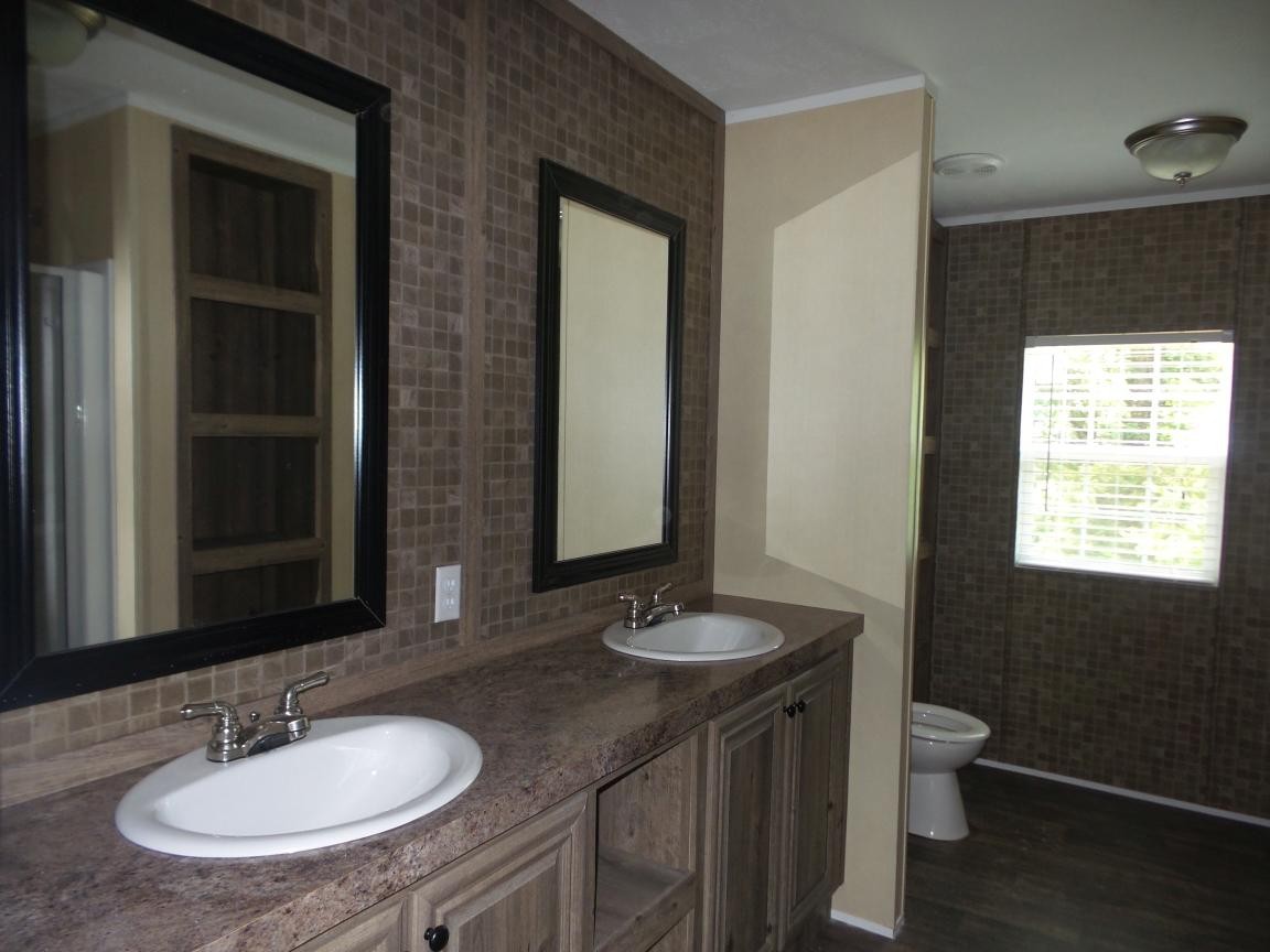 106 Webber Lane Clinton, TN 37716 - Photo 7 of 20 a bathroom with a granite countertop sink a toilet and a mirror