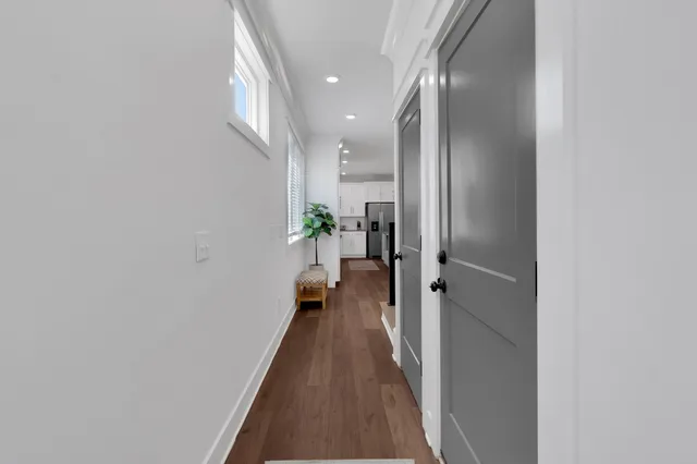 a kitchen with stainless steel appliances granite countertop a sink a stove a refrigerator cabinets and dining table