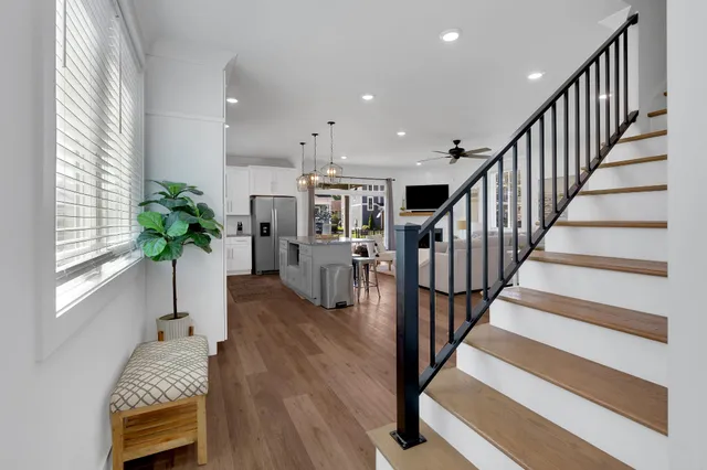 a view of staircase with wooden floor and a chandelier