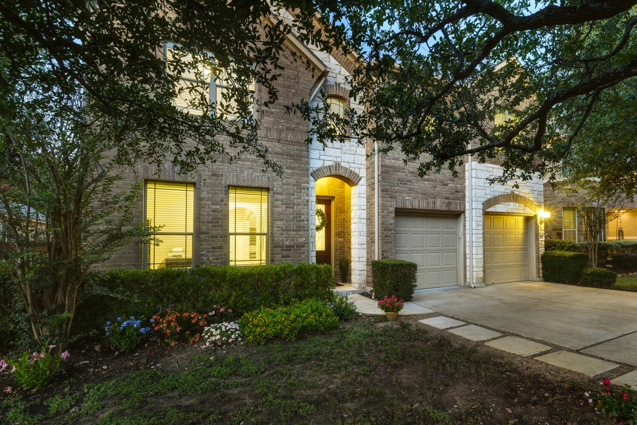 110 Dasher Drive Cedar Park, TX 78613 - Photo 1 of 39 A classic brick and stone facade welcomes guests with warm, inviting entry lighting.