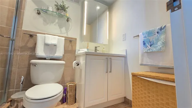 a bathroom with a toilet sink and shower