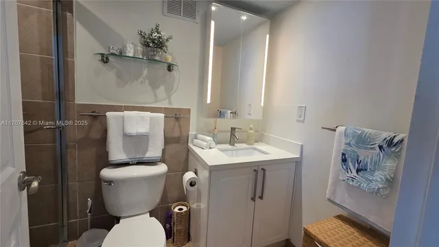 a bathroom with a toilet a sink and shower