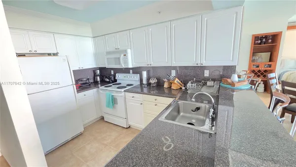 a kitchen with a sink a stove and cabinets