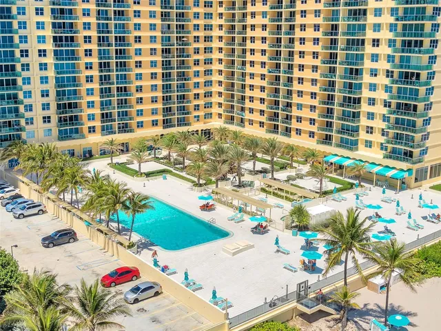 a front view of a multi story building with yard