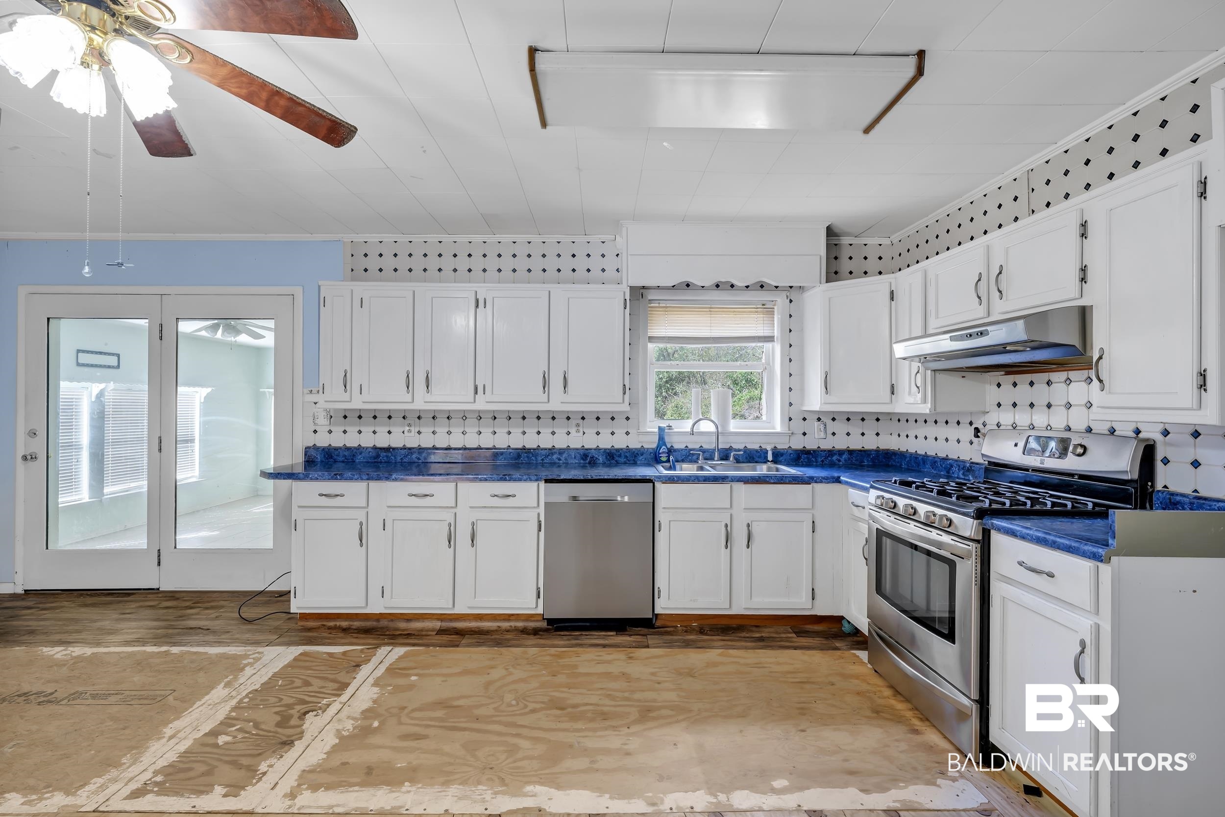 17463 Highway 98 Foley, AL 36535 - Photo 9 of 57 Kitchen featuring stainless steel appliances, white cabinets, dark countertops, ceiling fan, and backsplash