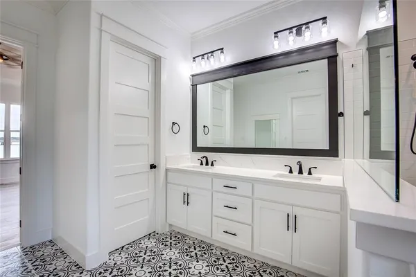 a bathroom with double vanity sink and a mirror