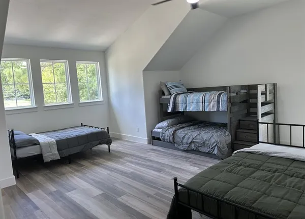 a bedroom with two beds and a couch