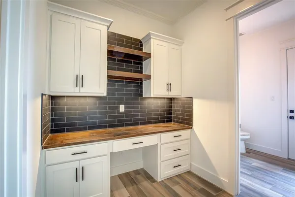 a kitchen with granite countertop white cabinets and white appliances