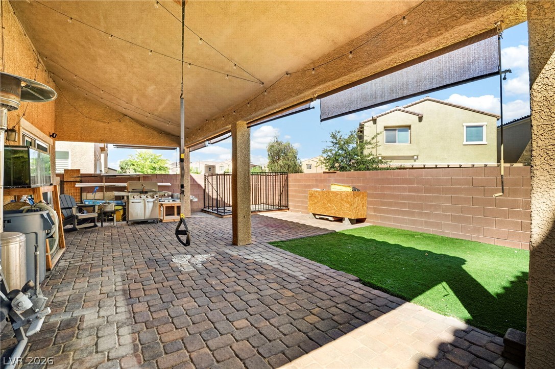 6281 Angora Peak Lane Las Vegas, NV 89115 - Photo 30 of 34 A spacious covered patio with pavers provides an ideal setting for outdoor entertaining and relaxation.