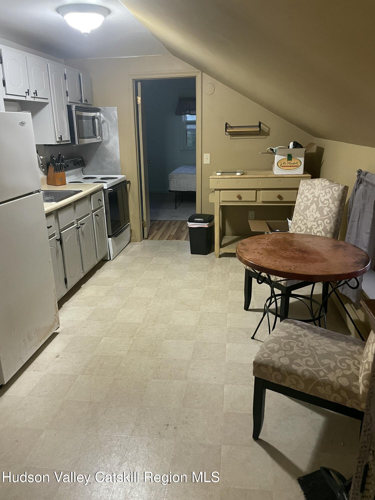 1218 Burlingham Road Pine Bush, NY 12566 - Photo 11 of 28 a living room with stainless steel appliances kitchen island granite countertop furniture and a refrigerator