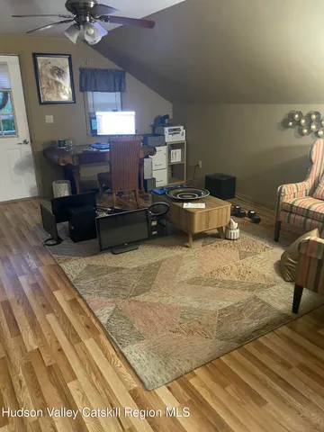 a view of a room with wooden floor