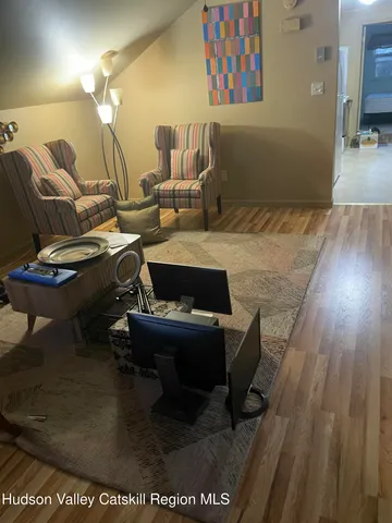 a view of a room with wooden floor