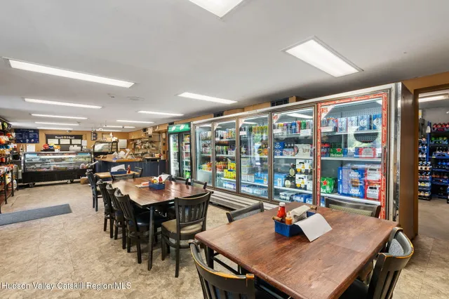 a dining room with furniture and a book shelf