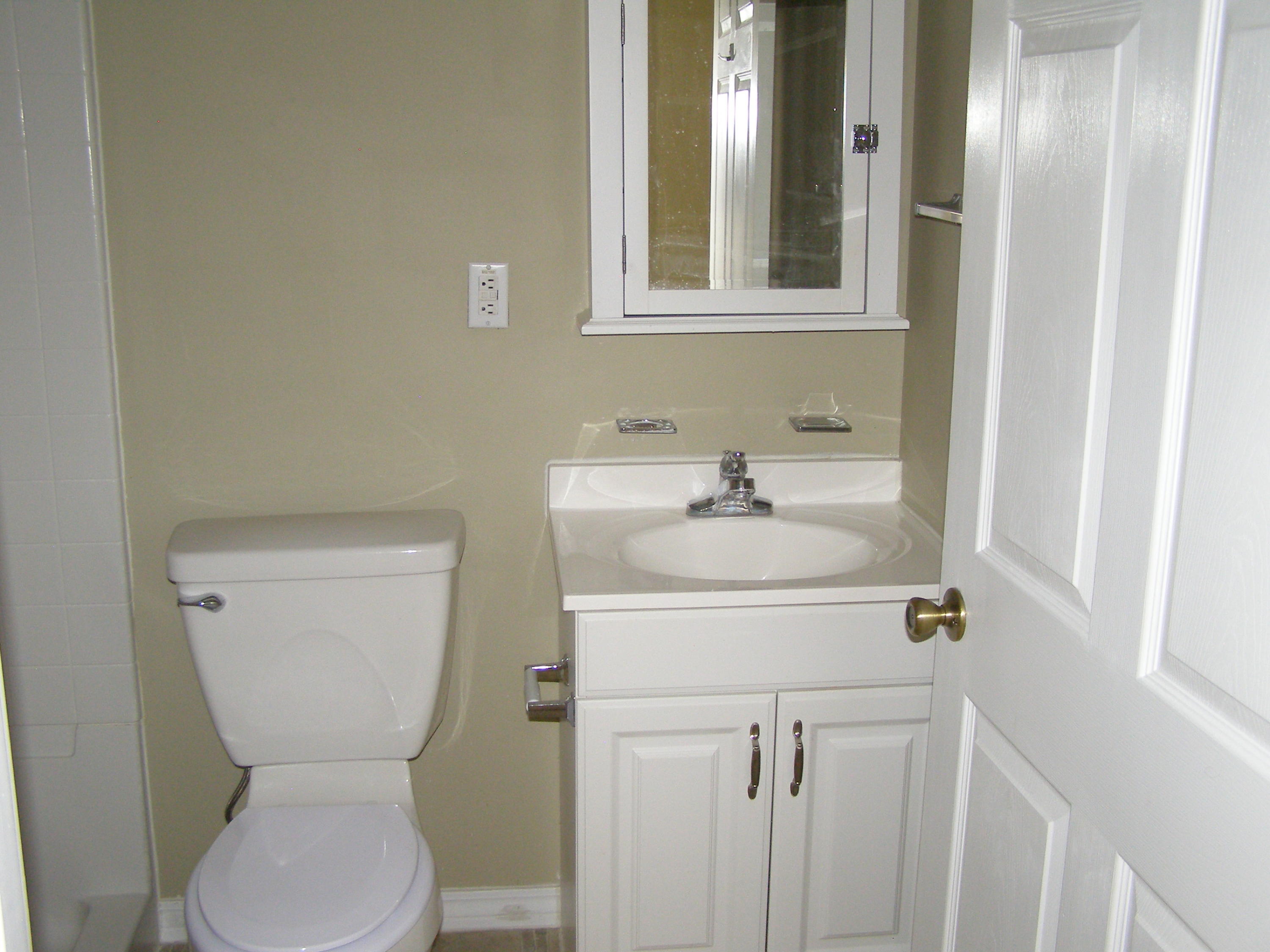 711 Ridge Lake Road Crestview, FL 32536 - Photo 18 of 24 a bathroom with a toilet sink and mirror