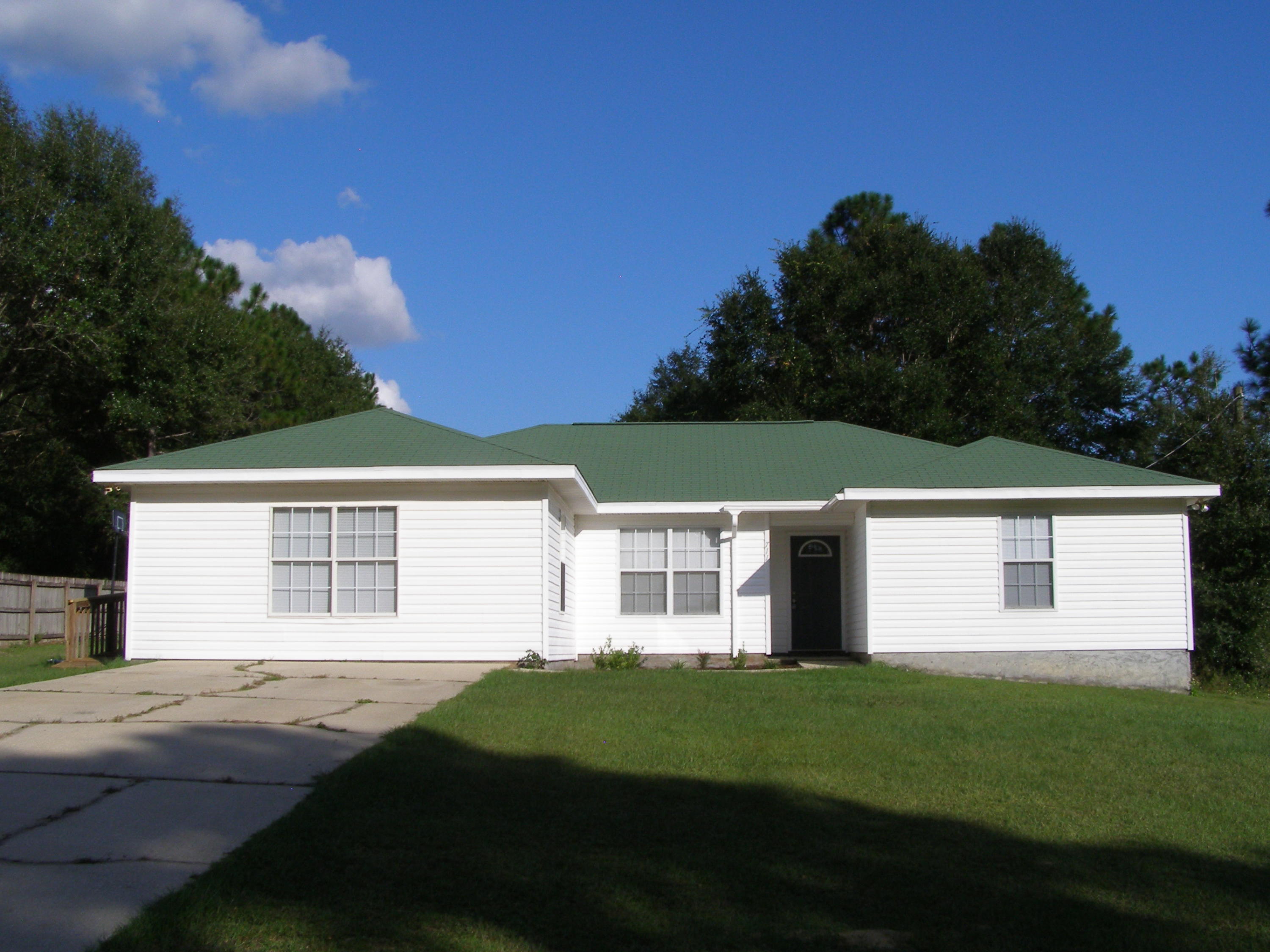 711 Ridge Lake Road Crestview, FL 32536 - Photo 2 of 24 a front view of a house with a yard