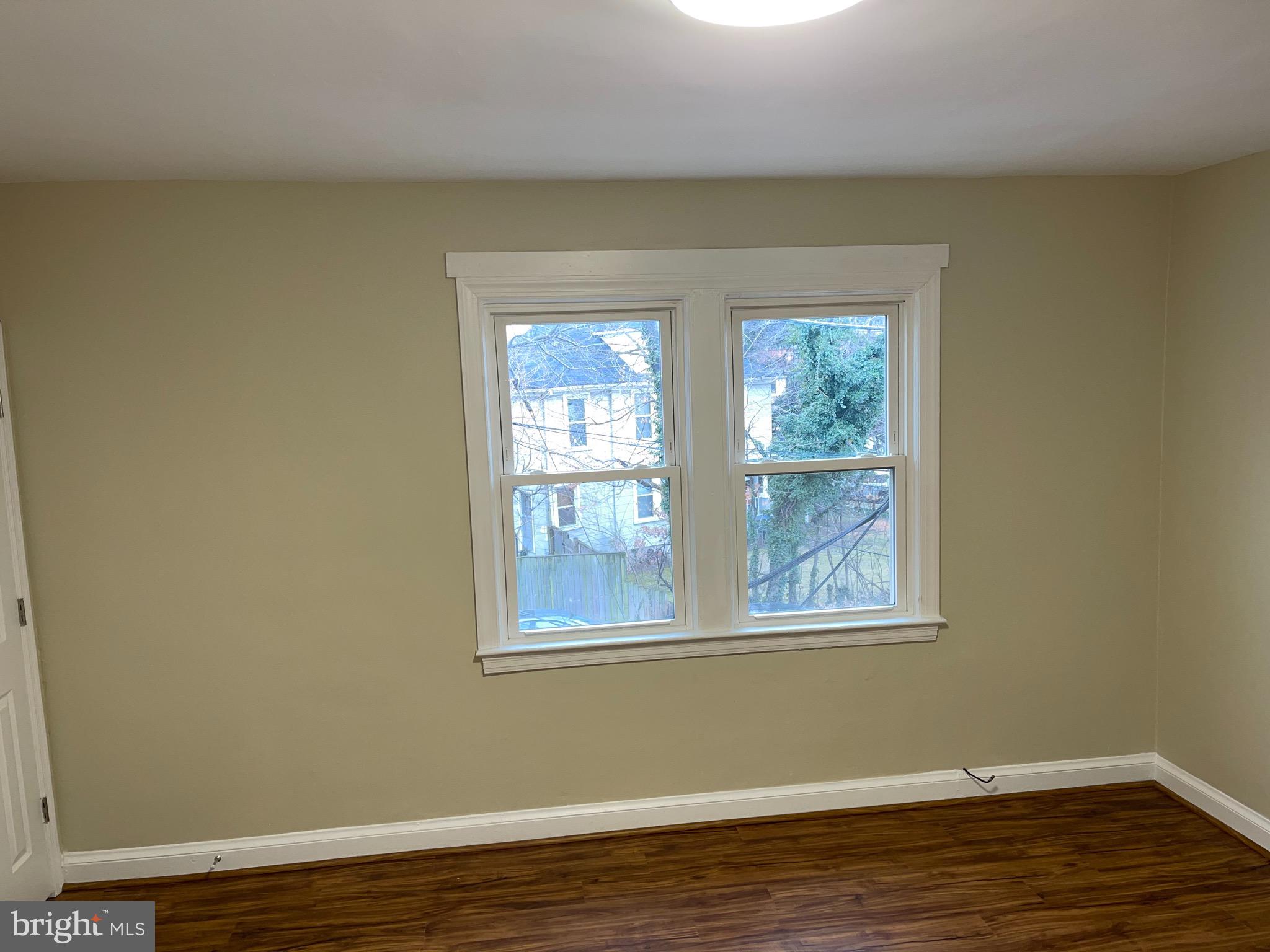 2210 Nicholson Street Southeast, Unit 3 Washington, DC 20020 - Photo 2 of 25 a view of a room with wooden floor and windows