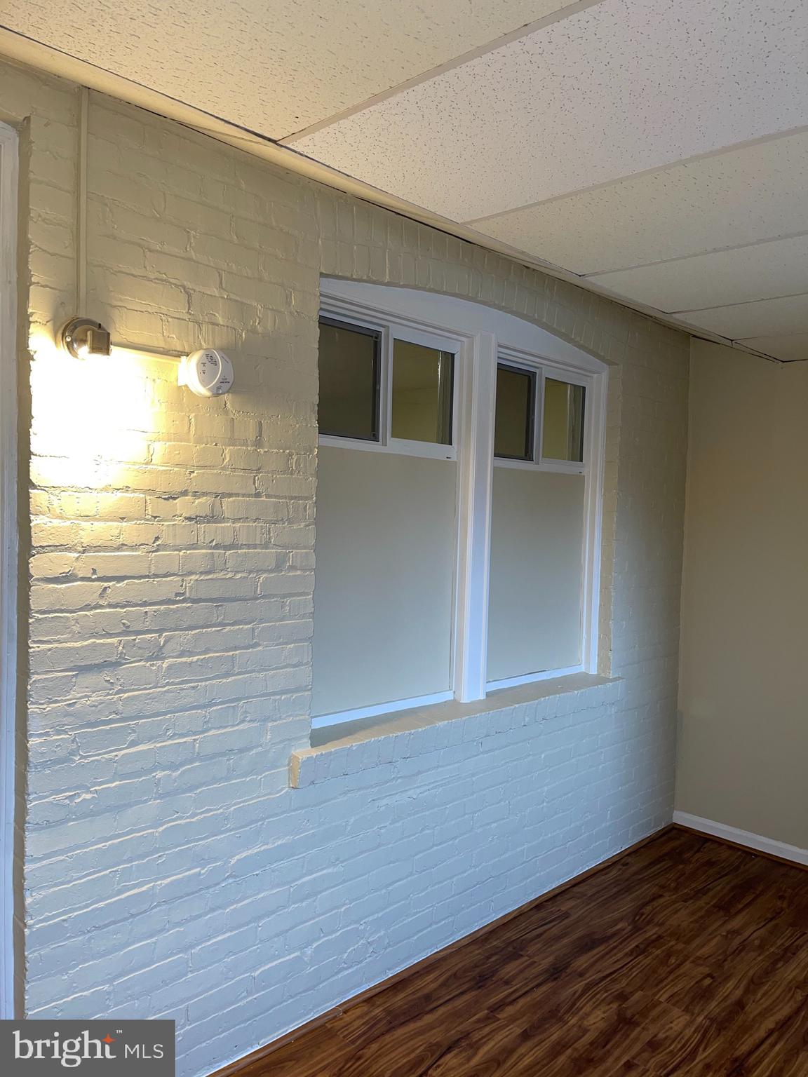 2210 Nicholson Street Southeast, Unit 3 Washington, DC 20020 - Photo 23 of 25 a view of an empty room with wooden floor and a window