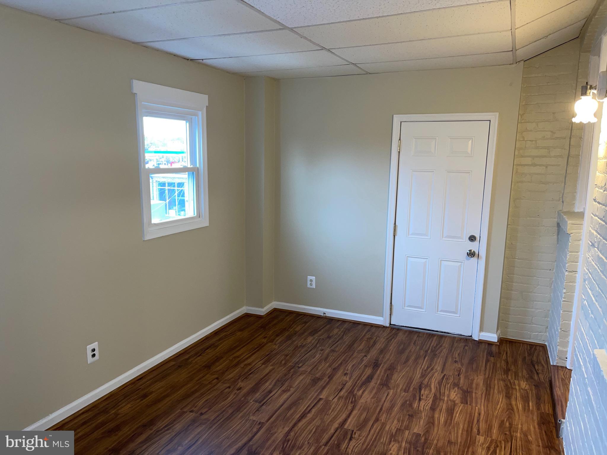 2210 Nicholson Street Southeast, Unit 3 Washington, DC 20020 - Photo 24 of 25 a view of a room with wooden floor and window