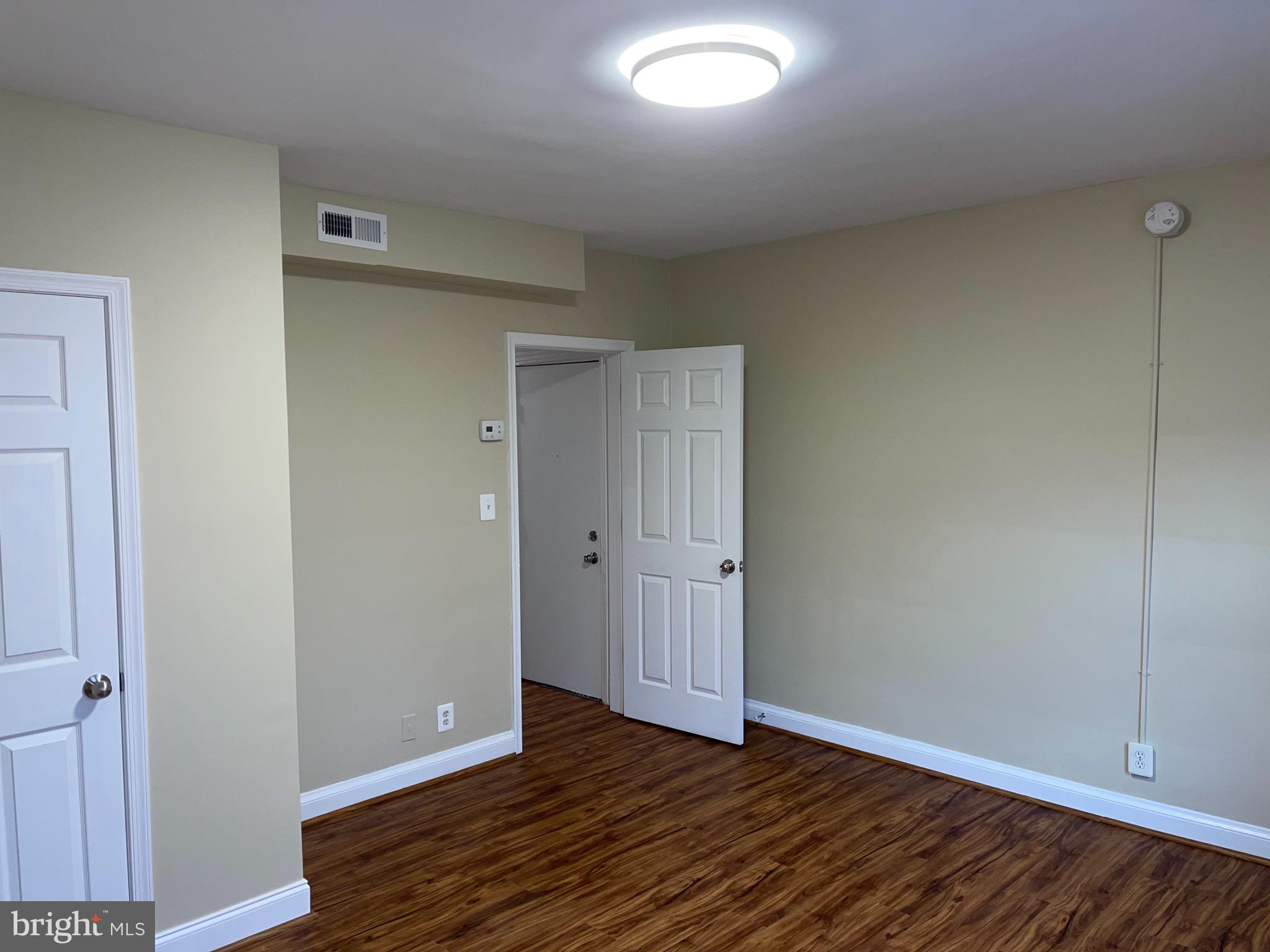 2210 Nicholson Street Southeast, Unit 3 Washington, DC 20020 - Photo 3 of 25 a view of an empty room with wooden floor