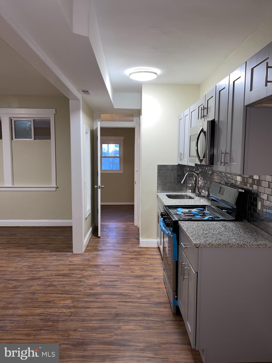 2210 Nicholson Street Southeast, Unit 3 Washington, DC 20020 - Photo 6 of 25 a kitchen with stainless steel appliances granite countertop a stove and a sink