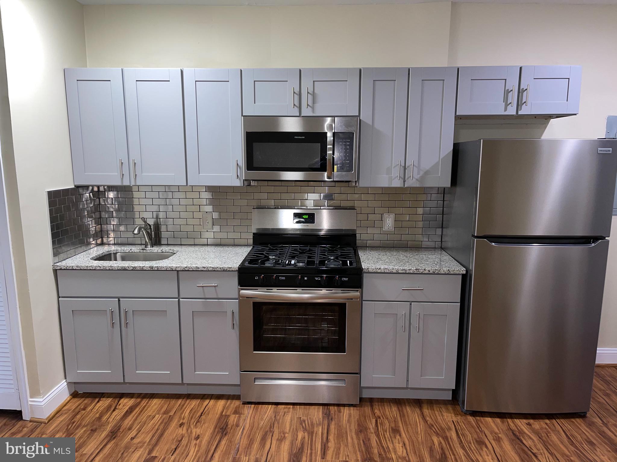 2210 Nicholson Street Southeast, Unit 3 Washington, DC 20020 - Photo 7 of 25 a kitchen with a sink stove and refrigerator