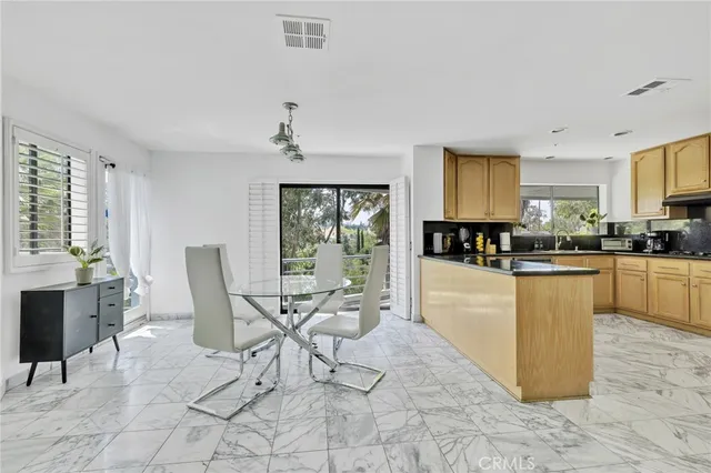 a living room with granite countertop furniture and kitchen view