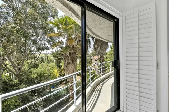 a view of a balcony with wooden floor and fence