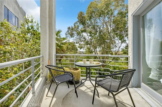 a view of a chairs and table on the balcony